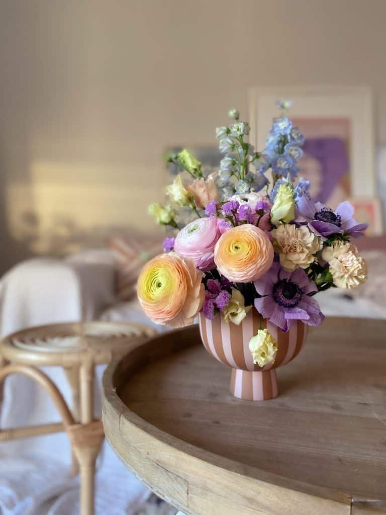 Schnittblumen auf historischem Couch-Tisch aus Holz